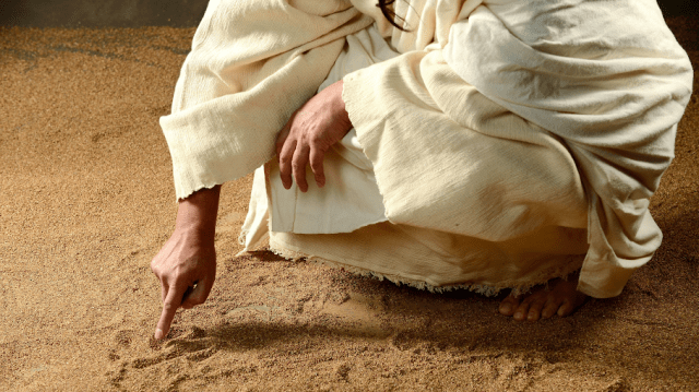 Jesus Drawing in Sand.png